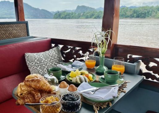 Canapés and cocktails on sundeck of Laos River Cruise