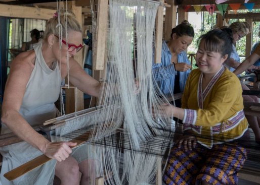 Tourist trying to weave silk in Ock Pop Tok