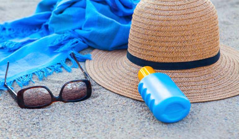 Sunscreen, sunglasses and hat